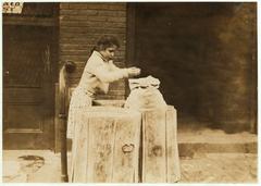 Girls scavenging through ash barrels in Boston, October 1909