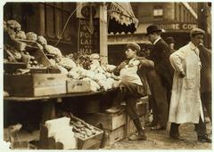 Young boy selling produce at a street stand in 1915 Boston