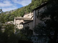 mountain landscape with historical monastery surrounded by greenery in Assisi