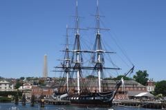 USS Constitution in Boston Harbor with Bunker Hill monument in background