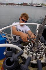 scientists setting up rosette water sampler on deck