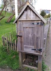 Wooden book exchange box on avenue du General-de-Gaulle in Saint-Lunaire