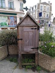 Wooden book-sharing box in front of the post office