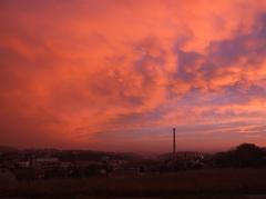 Red sky at dawn over a mountainous landscape