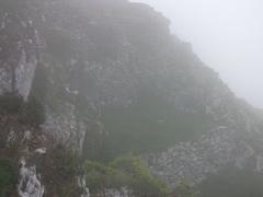 Ruins of Cathar buildings in the mist on the slopes of Montségur pog