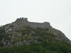 Chateau de Montségur on a hilltop against a blue sky