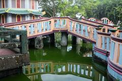 bridge over greenish water in Haw Par Villa