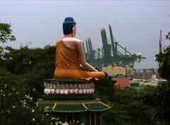 Buddha statue in front of gantries at Haw Par Villa, Singapore