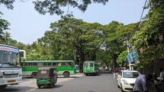 Ernakulam city skyline with buildings, trees, and a cloudy sky