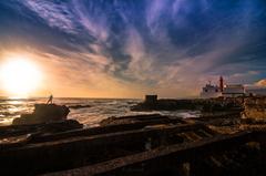 Sunset fisherman near lighthouse