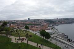 A panoramic view of Vila Nova de Gaia with the Douro River and traditional Portuguese architecture under a blue sky