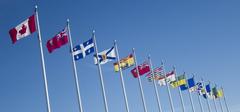 Flags of all thirteen Canadian provinces and territories outside the Canadian War Museum