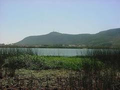 Morro de Osório, a prominent hill covered in lush vegetation under a clear blue sky