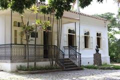 Neoclassical house with iron railing and bronze bust of Benjamin Constant