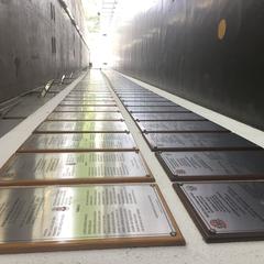 Plaques displaying the names of the graduating classes from courses offered by the Civil Police of São Paulo, located in the outdoor area