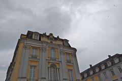 Swallows flying over Augustusburg Palace in Brühl, Rhineland, with approaching rain