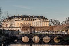 Schloss Augustusburg in Brühl seen from the southwestern part of the park, with the bridge over Mönchweiher in the foreground.