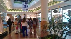 Interior of Parque Dom Pedro Shopping mall with modern architecture and glass ceiling