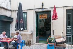 Rua São Miguel in Alfama, Lisbon with typical narrow streets and locals