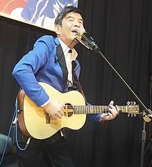 Joseph Yeh playing guitar at the Sanchong Air Force Military kindred Village No.1