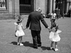 Man with two little girls in Piazza Plebiscito, Naples