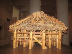 Side view of a Tày house model at the Vietnam Museum of Ethnology