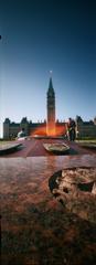 Peace Tower and Parliament Hill Centre Block framed by Centennial Flame in Ottawa