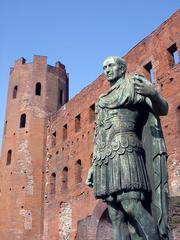 Porte Palatine in Turin with bronze statue of Caesar