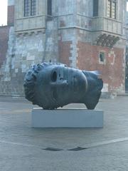 Igor Mitoraj's Eros Bendato bronze sculpture with Cracow town-hall tower in the background