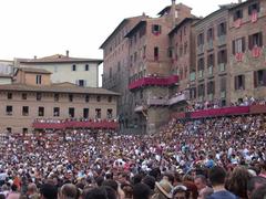 Piazza del Campo in Siena with people walking and historic buildings