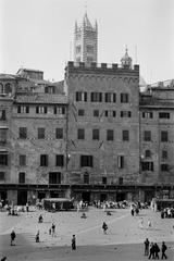 West side of Piazza del Campo in Siena, Italy with the tower of the Duomo in the background