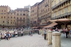 aerial view of Siena, Italy featuring historic buildings and lush landscape