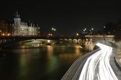 Long exposure of Seine River with light trails and historic buildings