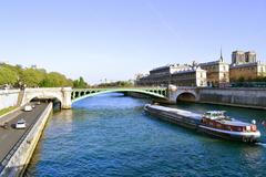 Pont Notre-Dame over the Seine River in Paris with a passing barge