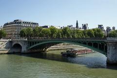 Pont Notre-Dame in Paris with buildings on the riverside and a clear blue sky