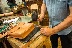 Pedro Sanudo, master leather craftsman, working with leather tools at Poble Espanyol