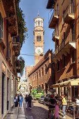 Piazza dei Signori in Verona, Italy with historical buildings and a statue under a clear blue sky