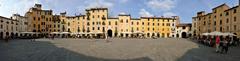 Panoramic view of Lucca showing its historic buildings, rooftops, and surrounding greenery