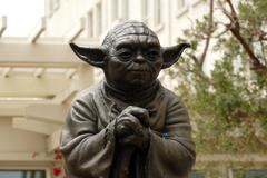 Yoda Fountain sculpture in a lush garden