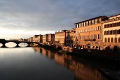 Florence at sunset with sun radiating through clouds