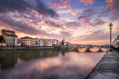 Sunset over Florence, Italy with a view of the Arno River and historic buildings