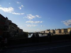 Arno River view with water reflections and surrounding buildings