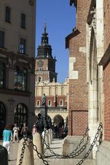 Mariacki Square with the sunny southern wall of St. Mary's Church, the Cloth Hall, and the Town Hall Tower in Kraków