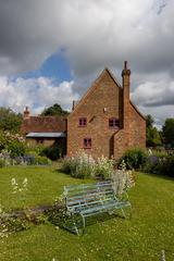 Timber-framed building in a green field