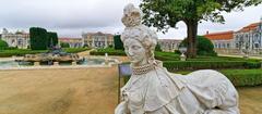 gardens of the National Palace in Queluz with manicured hedges and classical sculptures