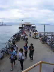 panoramic view of Lamma Island in Hong Kong with lush green hills, blue water, and scattered buildings