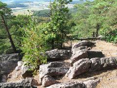 Scenic view of Babí lom with rocky terrain and lush greenery