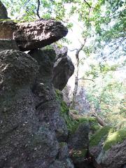 Scenic view of Babí lom with a lush green forest and rock formations