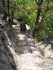 Scenic view of Babí lom with rocky terrain and lush green trees