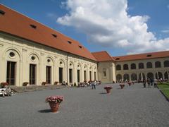 Panoramic view of Pražský hrad with the illuminated castle and historical buildings surrounding it.